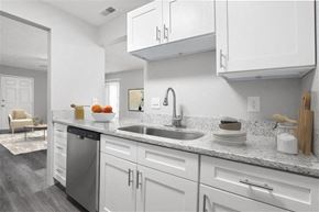 Lebanon apartment for rent - A modern kitchen with white cabinets and a stainless steel dishwasher at Parkview of Lebanon Apartments, Lebanon, IN