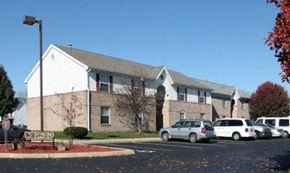 Lebanon apartment for rent - A white building with a grey roof and a parking lot in front at Parkview of Lebanon Apartments, Lebanon, Indiana