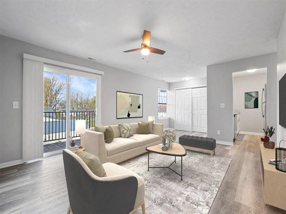Lebanon apartment for rent - A living room with a white couch and a grey armchair at Parkview of Lebanon Apartments, Indiana