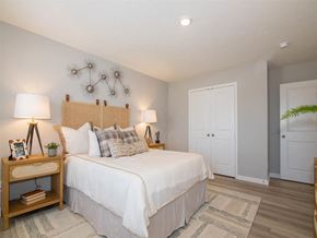 Whitestown townhouse for rent - Furnished bedroom with a bed and two side tables inside a home at Jackson Run Townhomes