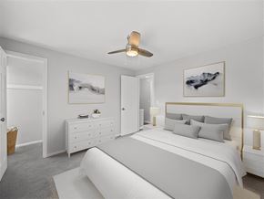 Kettering apartment for rent - A bedroom with a large bed and a ceiling fan at Huntley Ridge Apartments, Kettering 45419