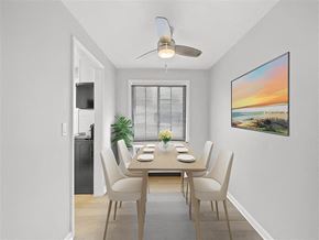 Kettering apartment for rent - A dining room with a table set for four and a painting on the wall at Huntley Ridge Apartments, Kettering, OH