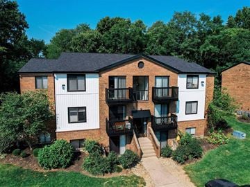 Milford apartment for rent - A multi-story apartment building with a balcony on the second floor.