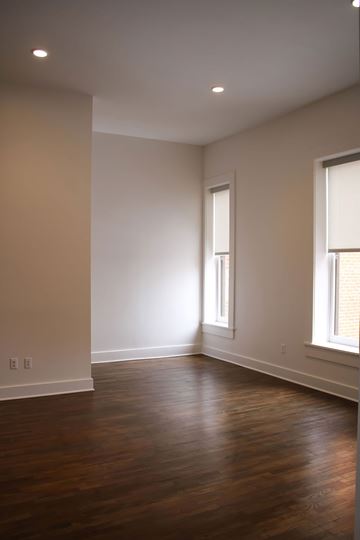 Van Wert apartment for rent - A room with wooden floors and two windows.