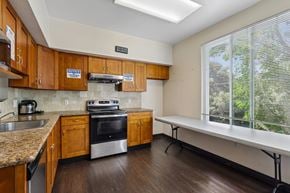 Palo Alto apartment for rent - A kitchen with wooden cabinets and a stove top oven.