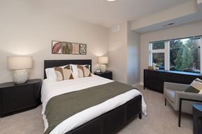 Roseville apartment for rent - A bedroom with a large bed and a chair.