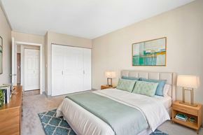 St. Paul apartment for rent - Virtually staged Irvine Park Towers bedroom with bed, nightstands and double closet doors
