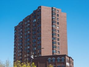 St. Paul apartment for rent - a tall brick apartment building against a blue sky