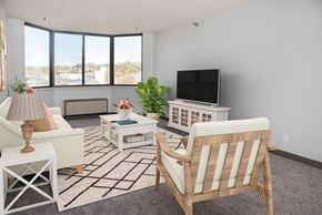 St. Paul apartment for rent - a living room with a couch and chairs and a television