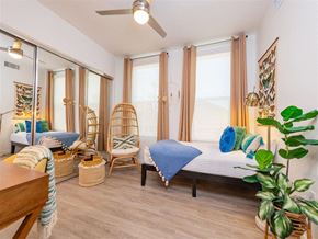 Chula Vista apartment for rent - A bedroom with a bed, chair, and potted plant.