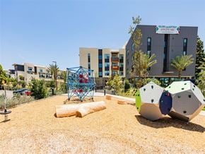 Chula Vista apartment for rent - A playground with a climbing structure and a building in the background.