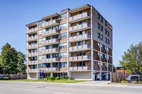 Hamilton apartment for rent - A large apartment building with balconies on the second floor.