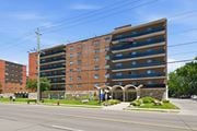 Hamilton apartment for rent - A large brick building with a parking garage on the top floor.