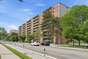 Hamilton apartment for rent - A street with cars and apartment buildings on the side.