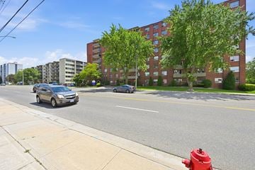 Hamilton apartment for rent - A red fire hydrant is on the sidewalk next to a street.
