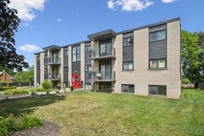 Waterloo apartment for rent - A modern apartment building with a red door on the ground floor.