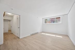 Kitchener apartment for rent - A room with a window and a door leading to another room.