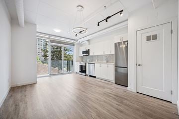 Kitchener apartment for rent - A kitchen with white cabinets and a refrigerator.