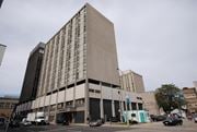 Hamilton apartment for rent - A large building with a flat roof and a grey facade.