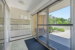 Hamilton apartment for rent - A view of a hallway with a bench and a window.