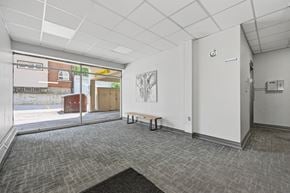 Hamilton apartment for rent - A room with a grey carpet and a white wall with a door.
