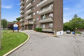 Hamilton apartment for rent - A tall apartment building with a Canadian flag on the balcony.