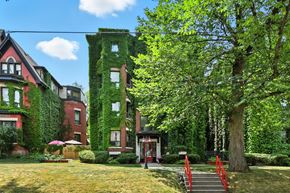 Hamilton apartment for rent - A red building with green vines growing on it.