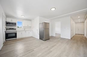 Kitchener apartment for rent - A kitchen with a refrigerator, oven, and microwave.