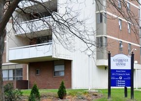 Kitchener apartment for rent - A sign for Kitchener Manor is in front of a brick building.