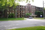 Hamilton apartment for rent - A large brick apartment building with a tree in front of it.