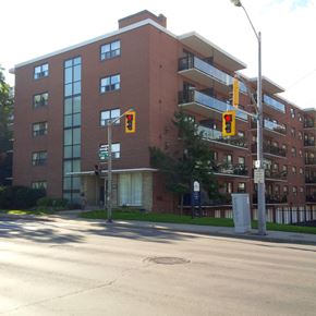 Hamilton apartment for rent - A red brick building with a balcony on the second floor.