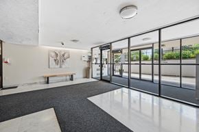 Hamilton apartment for rent - A hallway with a bench and a painting of an elephant on the wall.