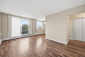 Hamilton apartment for rent - A room with wooden floors and white walls.