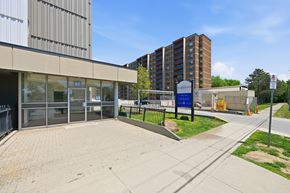 Hamilton apartment for rent - A building with a blue sign that says "857" is in the background.