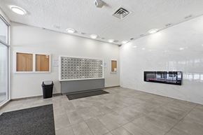 Hamilton apartment for rent - A white room with a grey carpet and a black trash can.