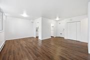 Hamilton apartment for rent - A room with wooden floors and white walls.