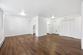 Hamilton apartment for rent - A room with wooden floors and white walls.
