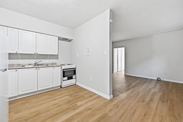 Hamilton apartment for rent - A kitchen with white cabinets and a wooden floor.