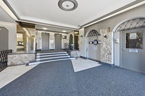 Hamilton apartment for rent - A hallway with a stone wall and metal gates.