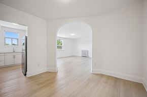 Kitchener apartment for rent - A spacious room with a window and a doorway leading to another room.