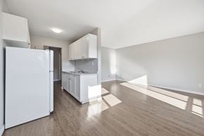 Hamilton apartment for rent - A kitchen with white appliances and cabinets is shown.
