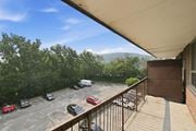 Hamilton apartment for rent - A parking lot with cars and a mountain in the background.