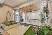 Hamilton apartment for rent - A room with a statue, a bench, and a planter with flowers.