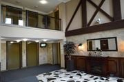 Hamilton apartment for rent - A room with a fireplace and a mirror on the wall.