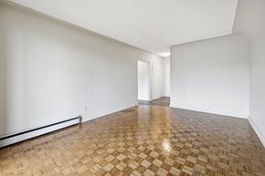 Hamilton apartment for rent - A room with a wooden floor and white walls.