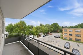 Hamilton apartment for rent - A balcony overlooks a parking lot and a building.