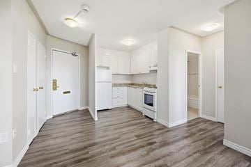 Hamilton apartment for rent - A kitchen with white cabinets and a wooden floor.