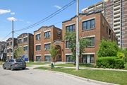 Kitchener apartment for rent - A street view of a residential area with a car parked on the side of the road.