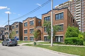 Kitchener apartment for rent - A street view of a residential area with a car parked on the side of the road.