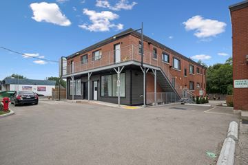 Kitchener apartment for rent - A building with a parking lot in front of it.